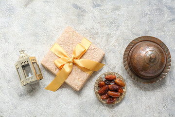 Fanoos, dates and gift box on white grunge background. Ramadan celebration