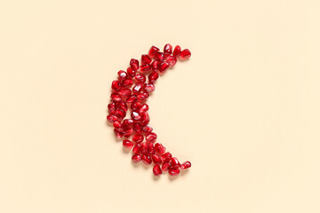 Crescent made of pomegranate seeds on color background. Ramadan celebration