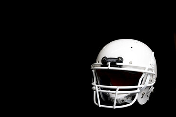 Naklejka premium football helmet isolated on black background, room for copy space