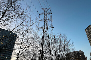 Electric transmission tower with buildings silhouette in Istanbul, Turkey.
