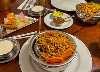 Pilaf with saffron and sauce in a metal bowl at a restaurant