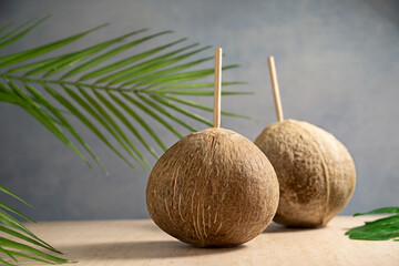 Fresh coconuts with straws, drinking coconut water