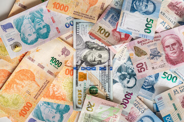 Close-up of Mexican, Argentine and dollar banknotes of different denominations