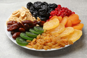 Mix of different dried fruits on grey table, closeup