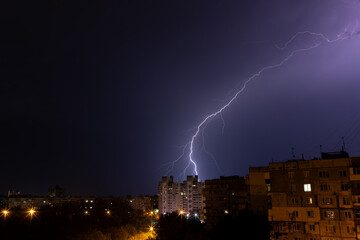 bright lightning in the night sky over the city