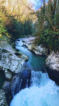 Waterfall in the picturesque Chernigov gorge in the mountains of the Caucasus. A mountain park in the Chernigov gorge with the Malaya Machara River, Abkhazia. Chernigovka