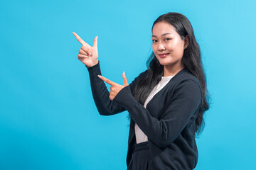 Asian woman with long black hair wearing a black cardigan and white shirt, smiling confidently...