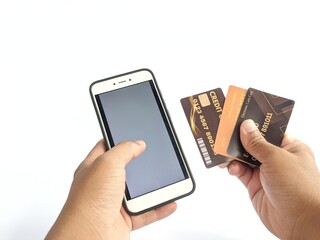 Hands holding a cell phone and credit card
