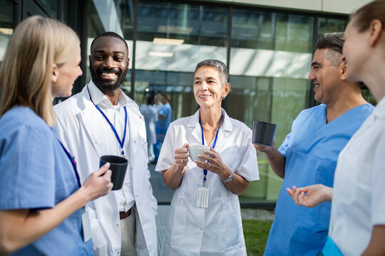 Healthcare professionals enjoying coffee break outside hospital