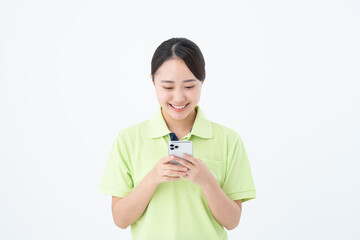スマホを使う若い介護福祉士の女性