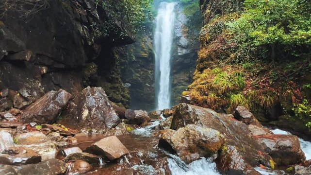 Holy waterfall of Abkhazia on a cloudy winter day in the mountains of the Caucasus. Mountain cascade waterfall. Eastern Abkhazia. Not far from the town of Tkvarcheli. Akarmara district.