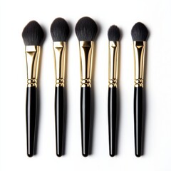 A set of five black and gold makeup brushes