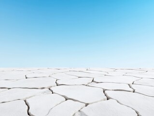 Expansive dry landscape with cracked earth under a clear blue sky