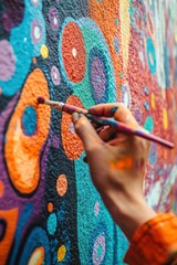 Obraz premium A close-up of an artist painting Holi murals on festival walls, intricate details and creativity in action