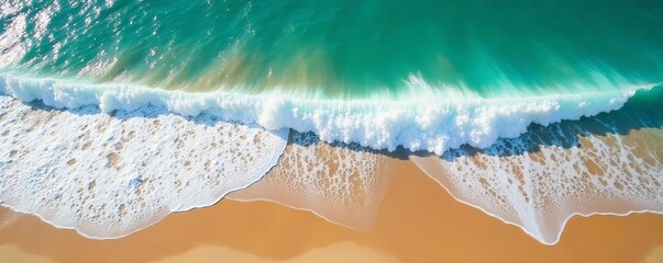 Obraz premium Aerial view of foamy sea waves breaking on sandy beach, tide, waves
