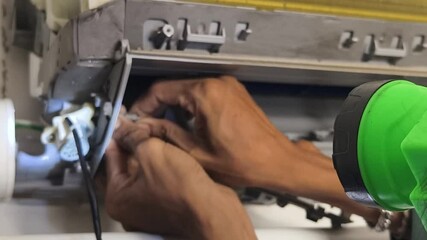 A technician repairs a wall mounted air conditioner and fixing HVAC systems