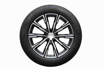 Obraz premium Winter tyre on white background. Close-up of a modern alloy wheel with a sleek, intricate spoke design. The tire is mounted, showcasing a high-performance aesthetic. Winter tyre safety.