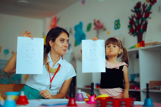 Preschooler Learning about Emotions with her Instructor in Kindergarten. School psychologist works with child to develop social skills
