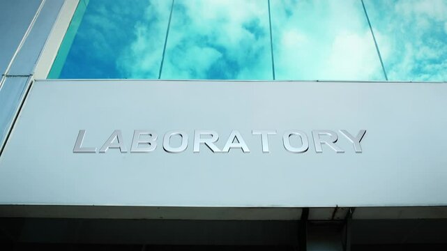Laboratory sign on a modern building with glass windows, symbolizing research, science, and innovation