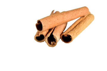 Aromatic dry cinnamon sticks lie on a white background