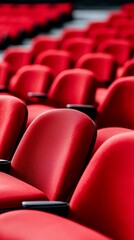 Obraz premium Rows of vibrant red theatre seats in an empty auditorium
