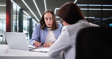 Female Tax Consultant Discussing Invoices Using Calculator