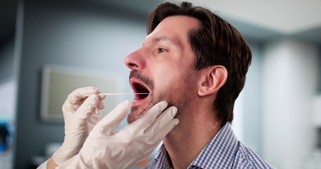 Medical Professional administering mouth swab DNA test © Andrey Popov