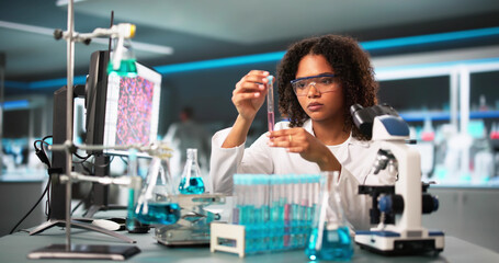 Scientist Looking At Test Tube