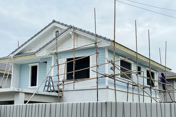 Construction site of housing project show house during construction with traditional bamboo scaffolding all around.Image use for property and real estate presentation background.
