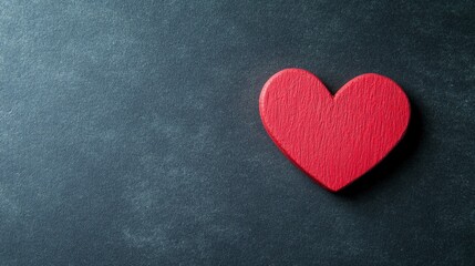 Obraz premium Red heart on black, soft gradient light, minimalist design. Symbol of love and simplicity in a bold visual statement. 