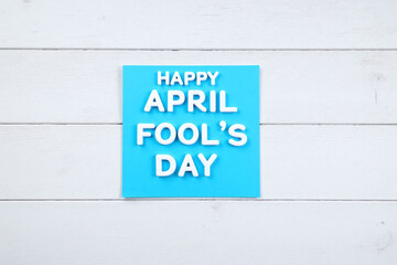 blue sticky note with the words Happy April Fools Day written on it