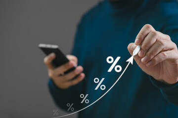 A professional examining financial growth through graphs displayed on a smartphone, representing investment strategy and market analysis.