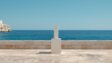 Fototapeta premium A white stone pillar stands on a stone platform overlooking the ocean.