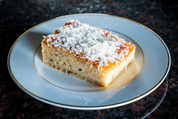 A tasty dessert on a fine plate, topped with grated cheese and sweet allure