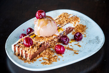 Savor a festive Christmas dessert topped with cherries and creamy ice cream!