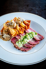 Savory roasted meat pairs with elegantly plated pasta and exquisite sauce, a culinary delight