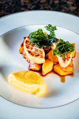 Grilled steak rests on roasted veggies, tempting appetites in a cozy setting