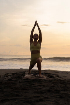 Indonesia, Bali, woman practising yoga at the coast