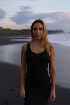 Beautiful woman in long dress on the beach at sunset. Bali