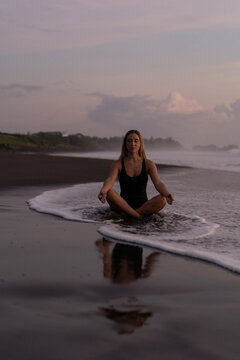 Beautiful woman in long dress on the beach at sunset. Bali