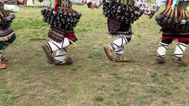 Traditional Kukeri dances and feet of dancers wearing tservuli