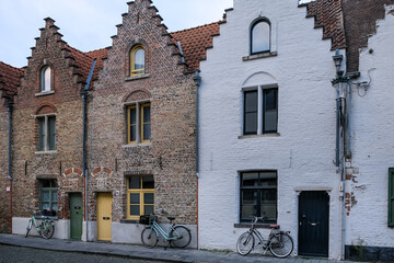 Bruges, Belgium – Traditional Flemish stepped-gable houses line this charming street, showcasing...