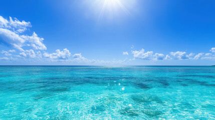 Fototapeta premium Serene Blue Ocean with Sunlight and White Clouds Above in a Tropical Paradise