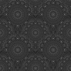 Abstract seamless pattern in a dark palette with grey ethnic ornaments on a black background. Oriental and Asian-inspired designs with circular patterns or mandalas.