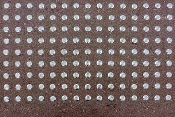 Warning surface with tactile indicators for visually impaired pedestrians