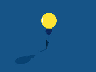 Businessman holding a balloon of knowledge light bulb
