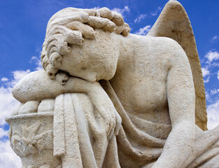 Tired angel warrior resting after battle on sky background