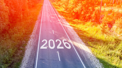 A road with the number 2016 written on it. The road is empty and the sky is orange