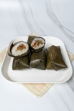 Lontong Isi - Indonesian traditional food, Lontong isi is rice filled with oncom or vegetables and wrapped with banana leaves . Lontong is a popular food during Ramadan. Potrait Photo