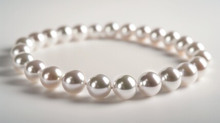 Obraz premium A pearl necklace outline with round beads strung evenly on a fine thread on a white background.